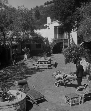 Bette Davis's chauffeur wheels her around in the backyard in Beverly Hills in 1939